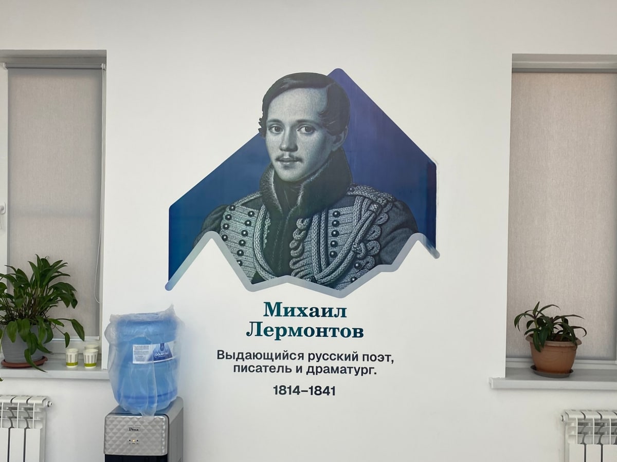 Портрет Михаила Лермонтова на синем фоне между двумя окнами